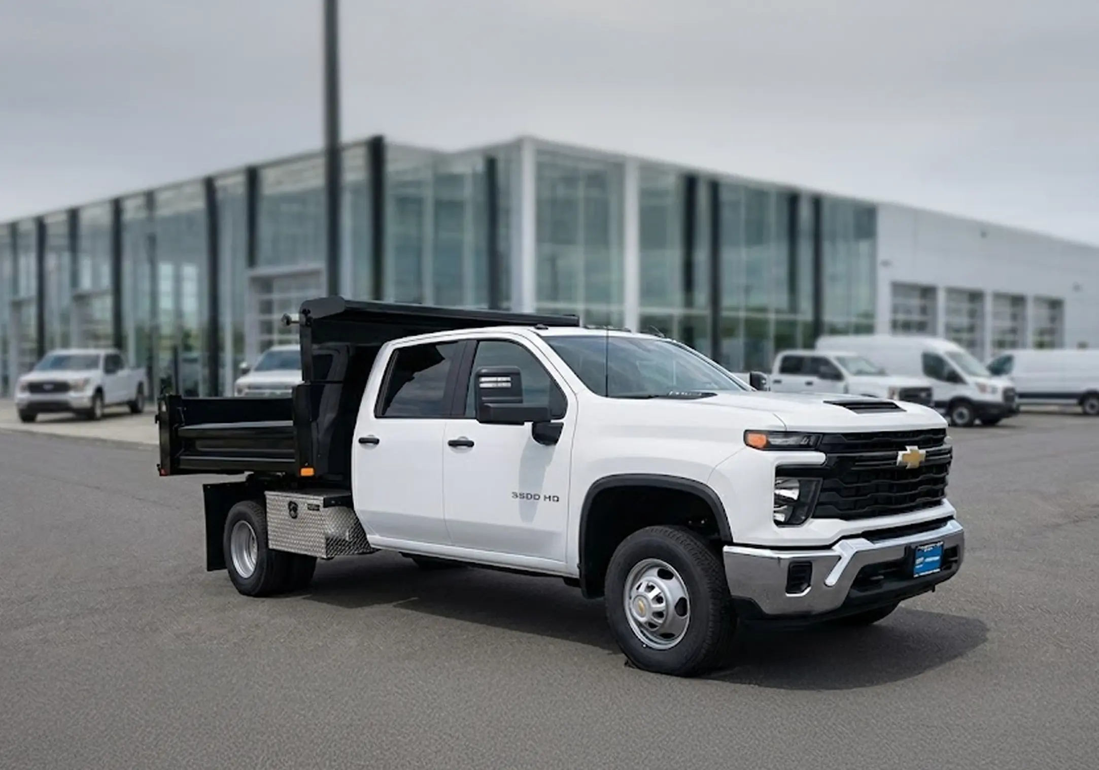 Silverado 3500HD with black Knapheide Mason dump body, front three-quarter view